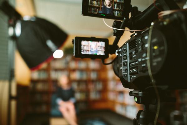 interview being recorded with film camera