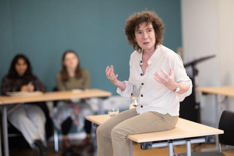 Jeanette Winterson sat on desk at writing workshop